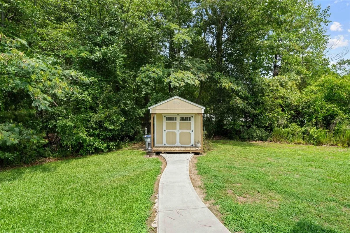 Storage shed with concrete walkway